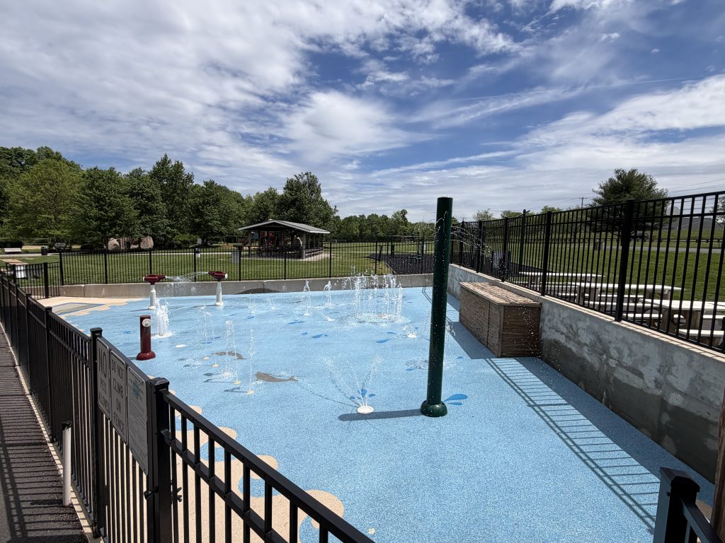 Image of splash pad with sprinklers flowing water.