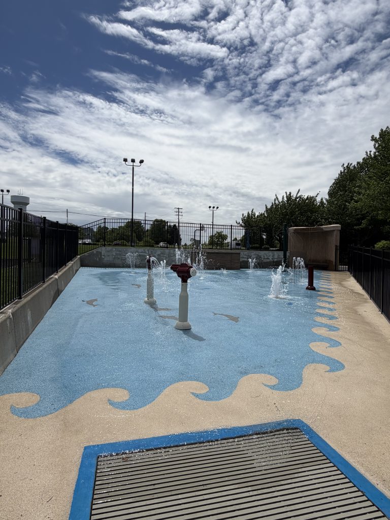 Image of splash pad with sprinklers flowing water.